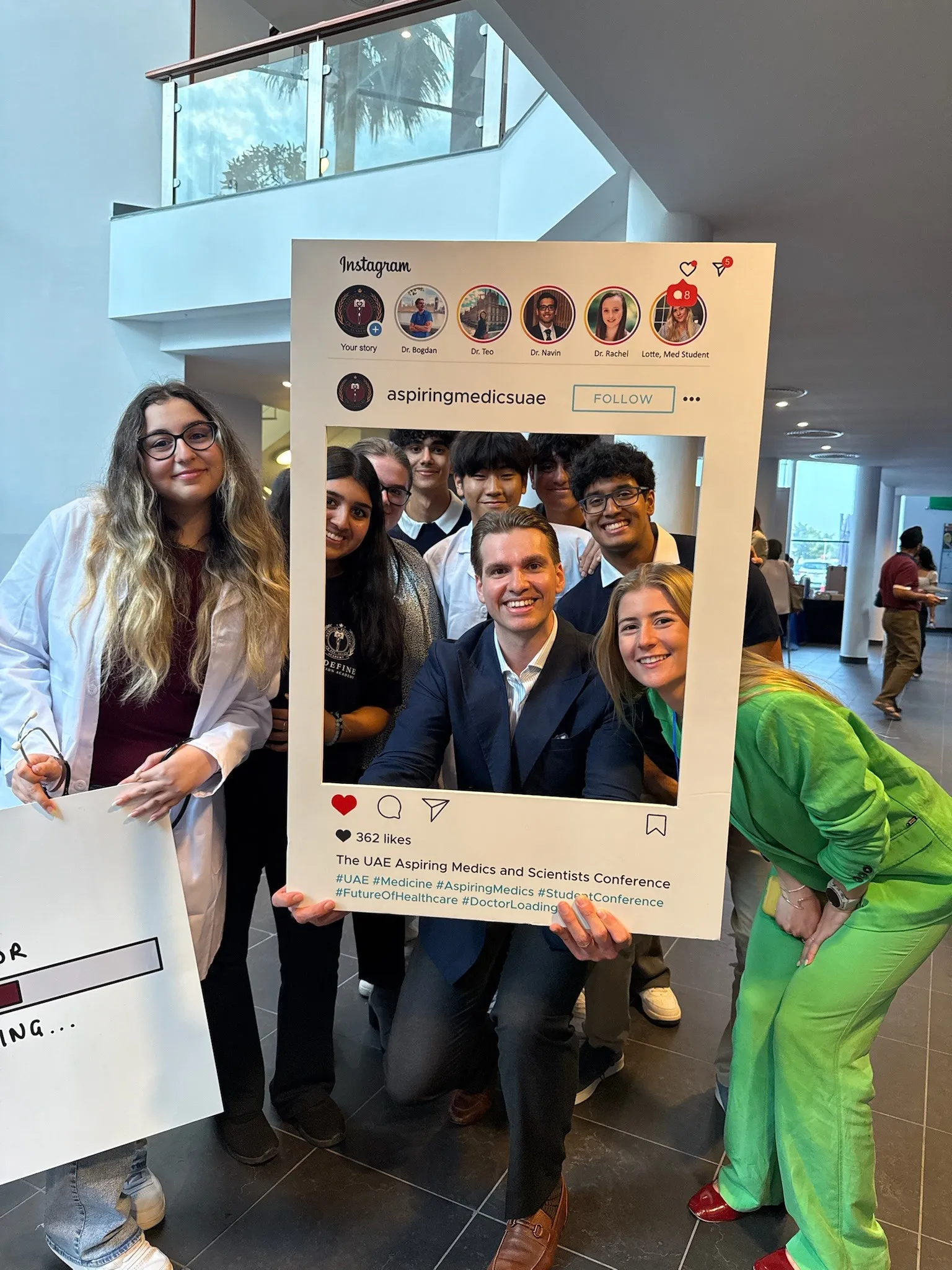 Students and a doctor posing in an Instagram photo frame at the UAE Aspiring Medics and Scientists Conference