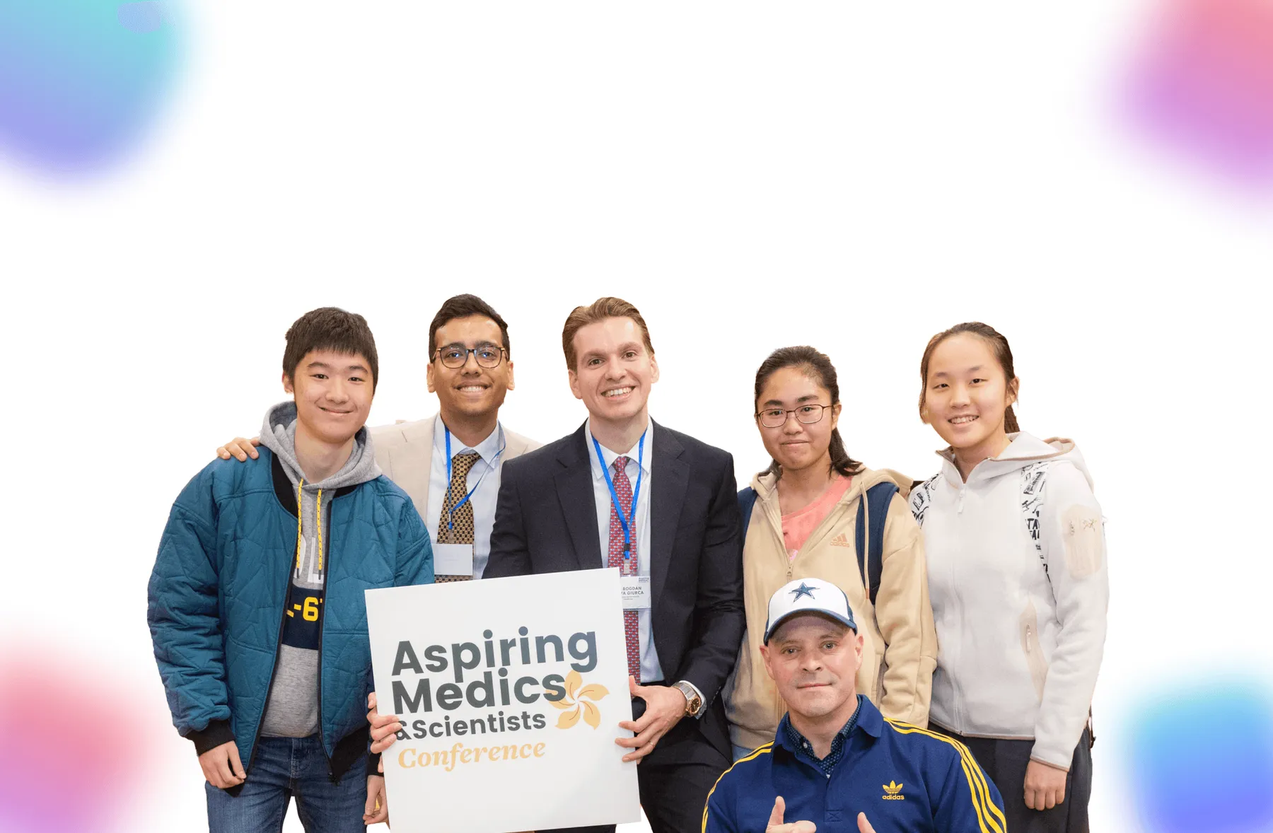 Students and speakers holding the conference sign